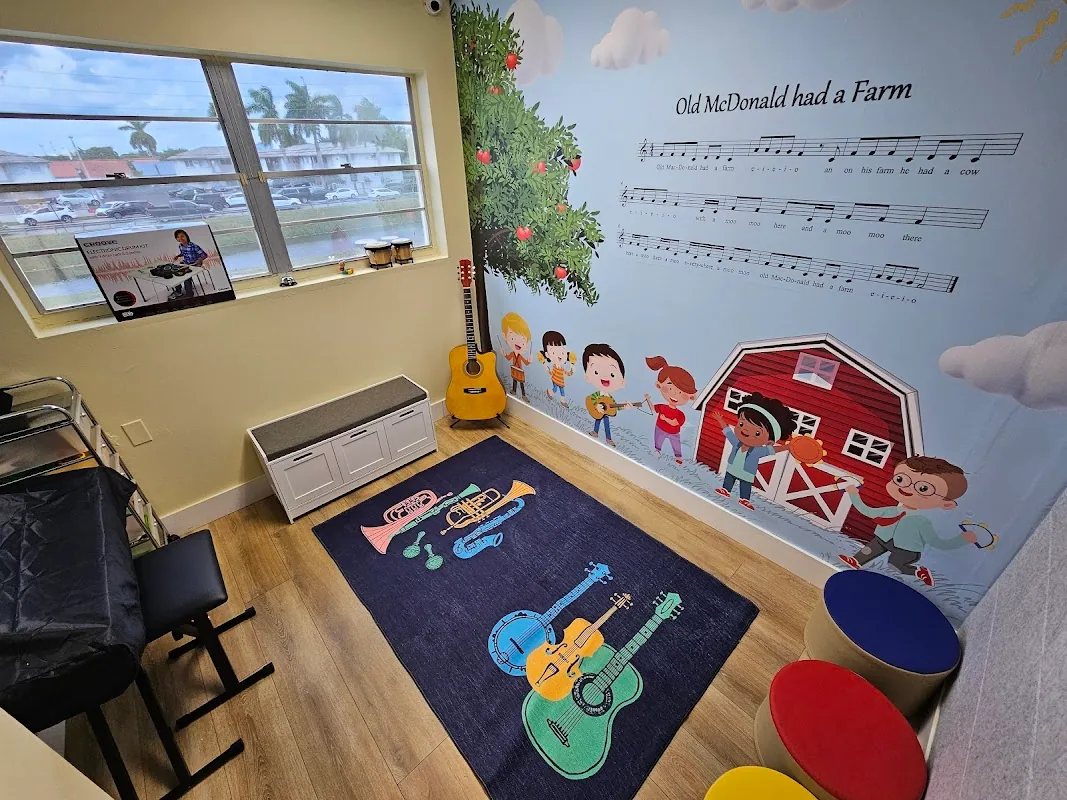 Music therapy room with an 'Old McDonald had a Farm' wall mural showing children and farm animals, and a children's guitar-themed rug on the floor
